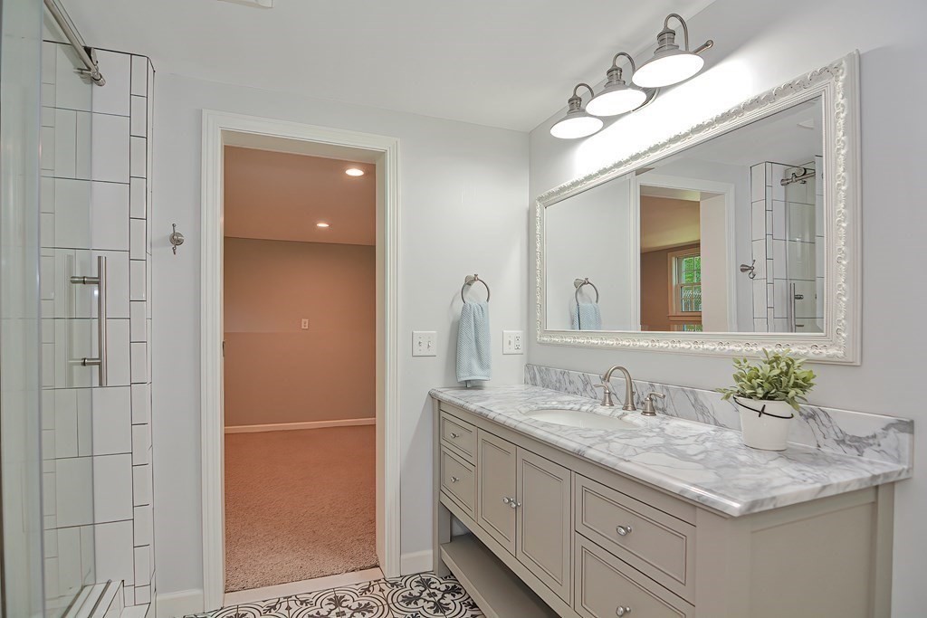 2 Labo Lane Bedford, MA 01730 - Photo 31 of 40 a bathroom with a granite countertop sink and a mirror