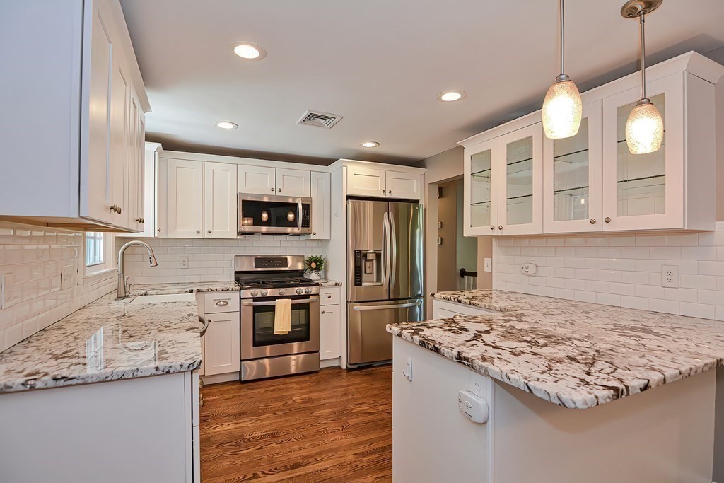 2 Labo Lane Bedford, MA 01730 - Photo 5 of 40 a kitchen with a stove and a refrigerator