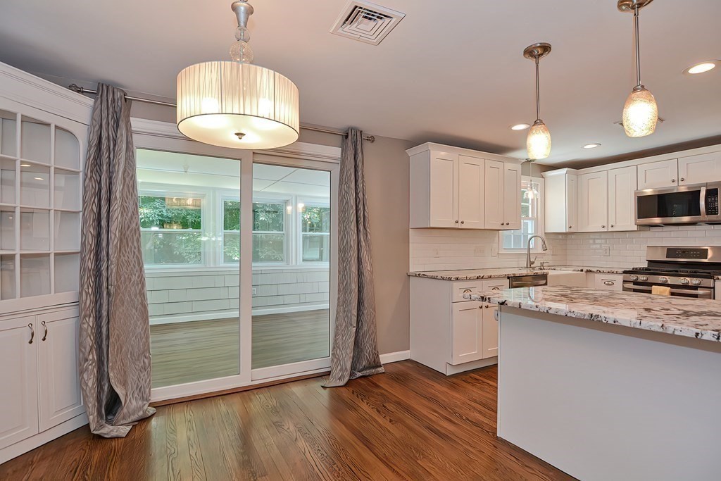 2 Labo Lane Bedford, MA 01730 - Photo 7 of 40 a kitchen with wooden floor and a window