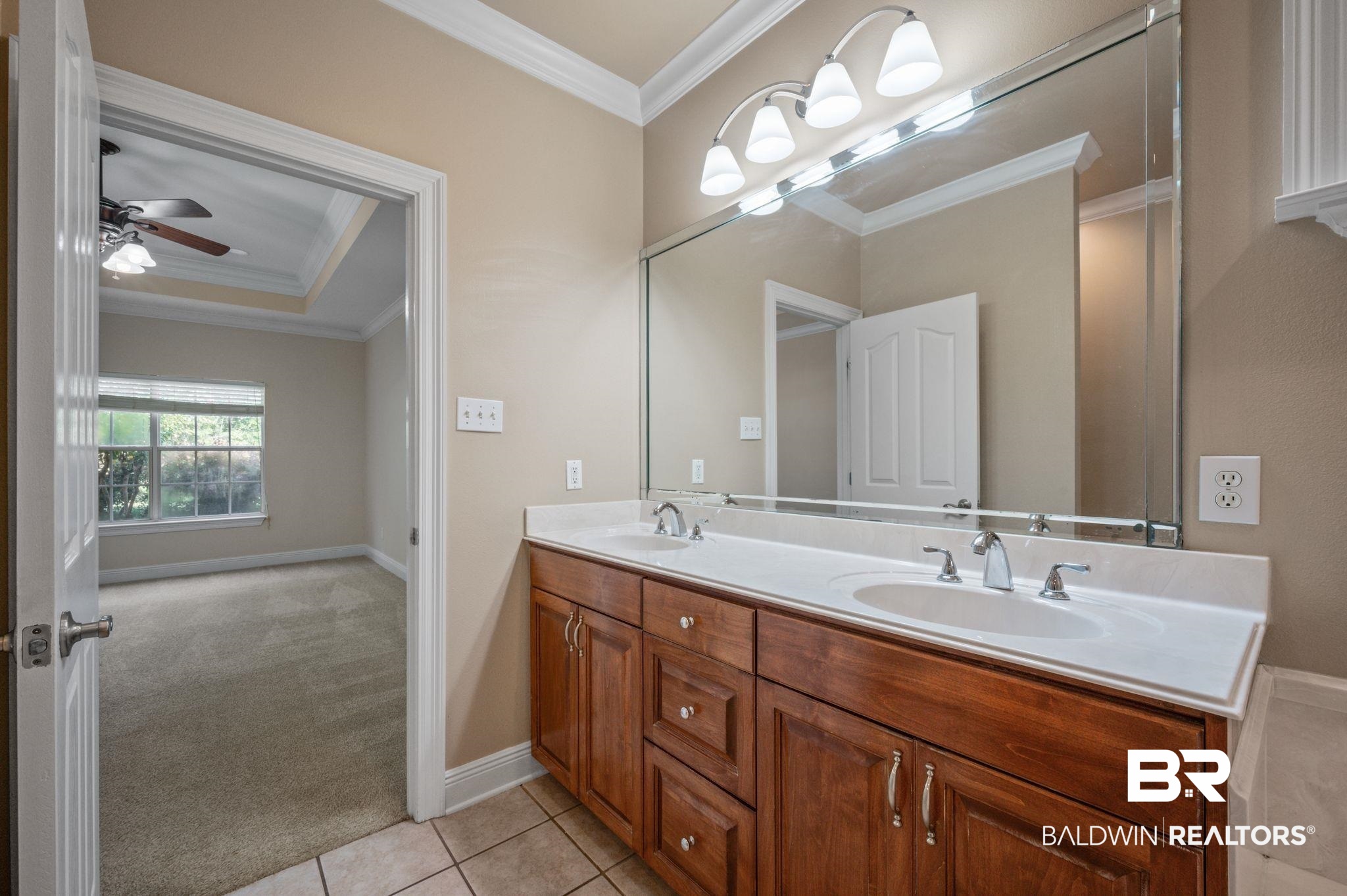 2041 Ridgeline Drive Mobile, AL 36695 - Photo 17 of 43 Bathroom featuring tile patterned floors, crown molding, ceiling fan, and dual bowl vanity