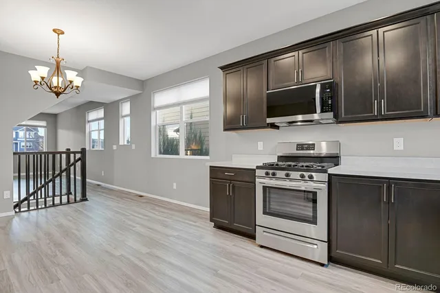 a kitchen with stainless steel appliances granite countertop a stove and a microwave