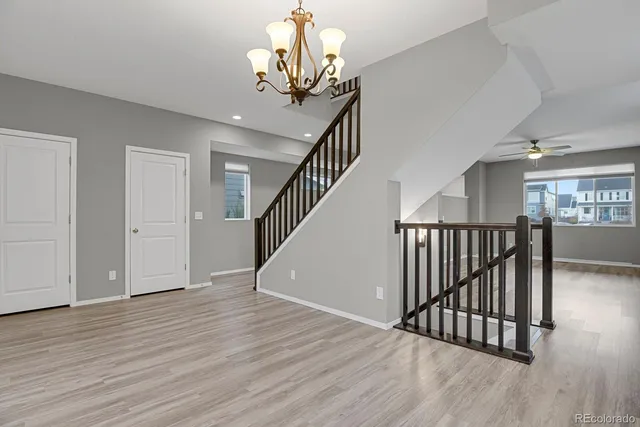 a view of a livingroom with wooden floor and staircase