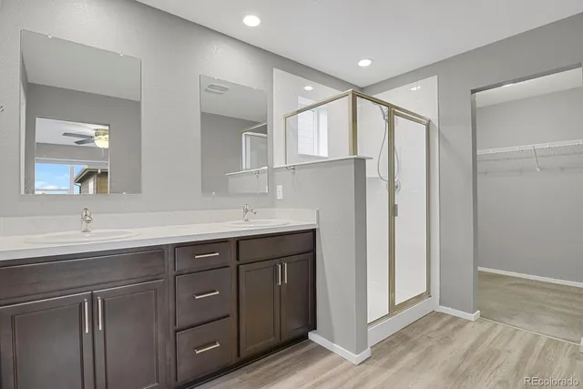 a bathroom with a double vanity sink and a mirror