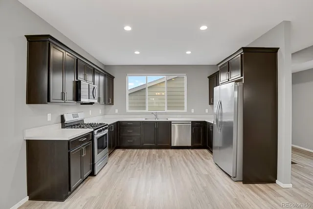 a large kitchen with a large stove top oven and refrigerator