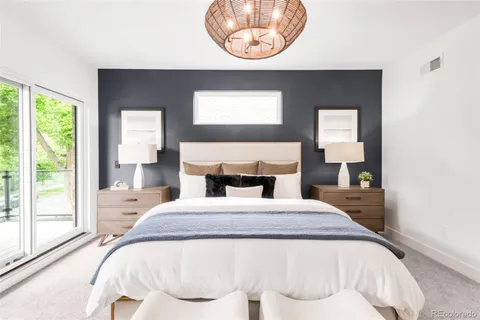 a bedroom with a bed and a large window