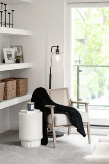 a living room with a window and a table