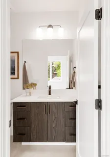 a bathroom with a sink vanity and mirror