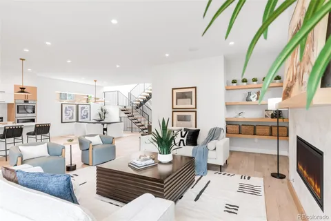 a living room with furniture a table and a potted plant