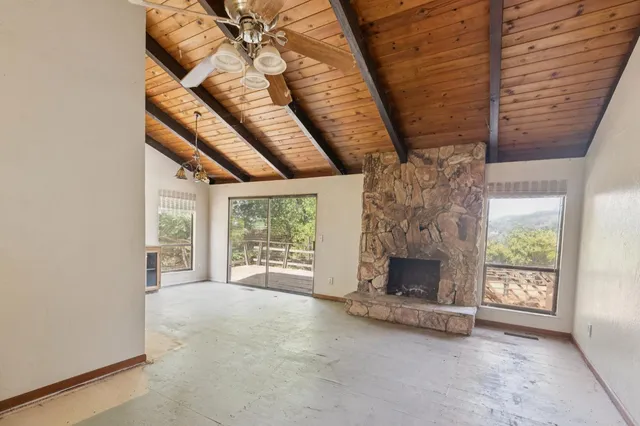 an empty room with furniture and fireplace