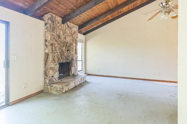 a view of an empty room with a fireplace