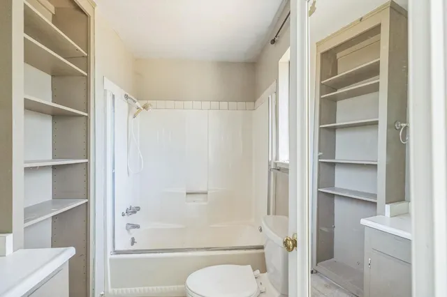 a bathroom with a shower and a toilet