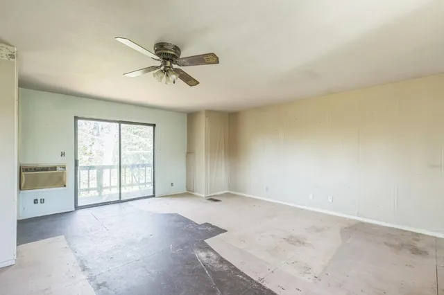 a view of a livingroom with a ceiling fan and window