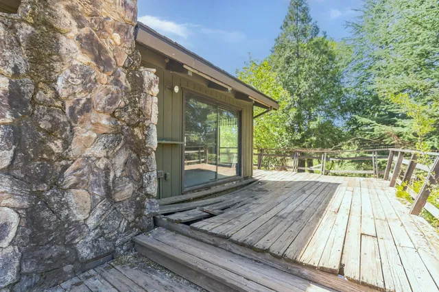 a view of backyard with wooden floor and fence
