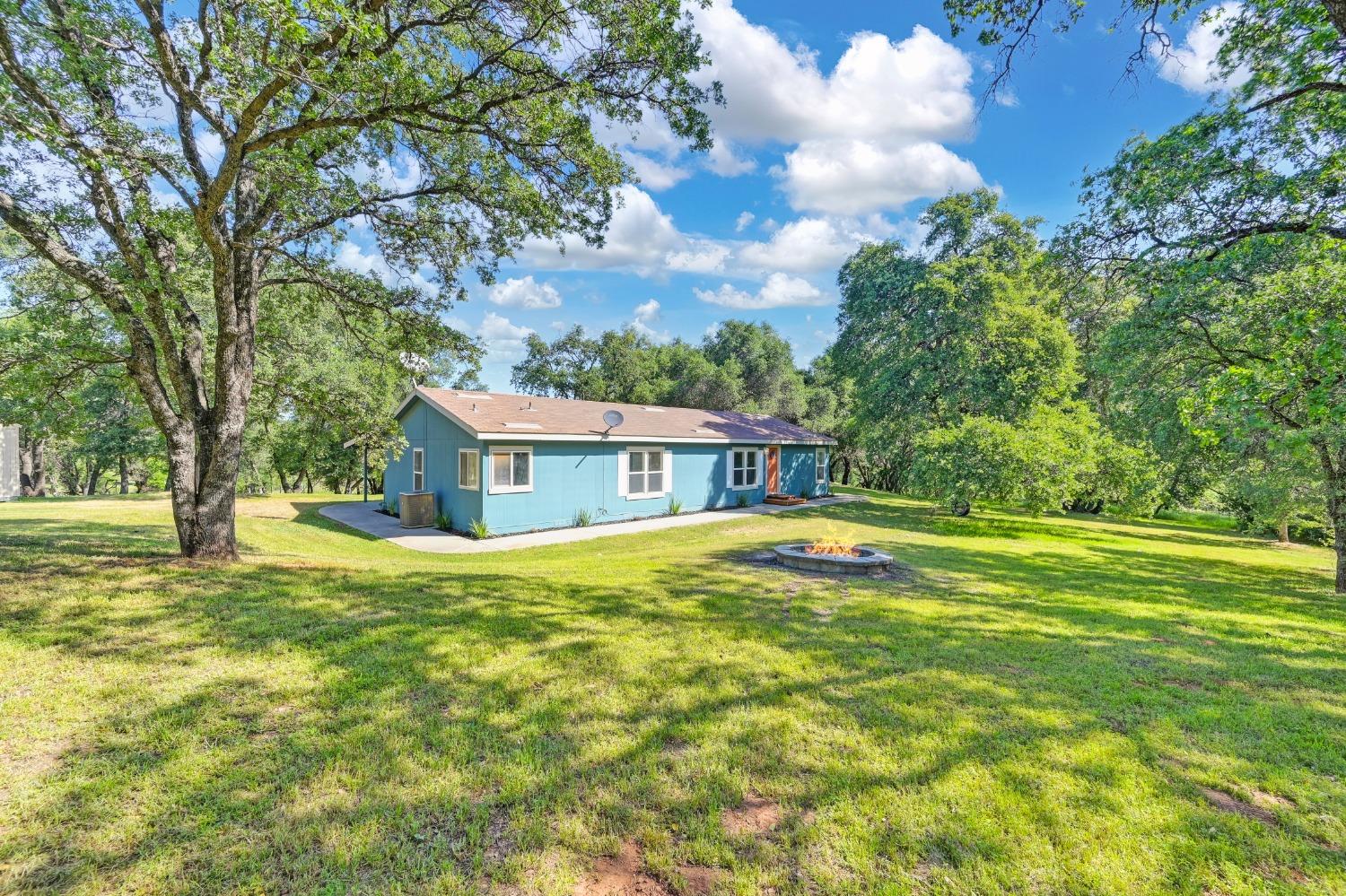 22770 Perimeter Road Grass Valley, CA 95949 - Photo 1 of 1 a view of a house with a big yard and large trees