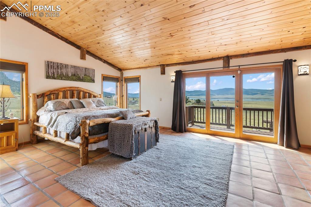 790 Tiara Road Lake George, CO 80827 - Photo 19 of 47 a bedroom with a bed and a large window