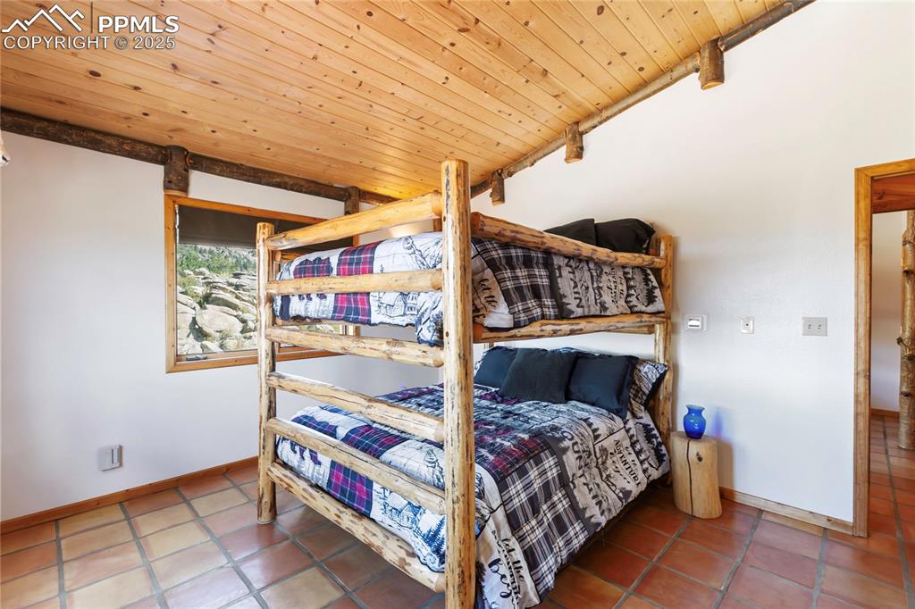 790 Tiara Road Lake George, CO 80827 - Photo 23 of 47 a bedroom with a bed and a window