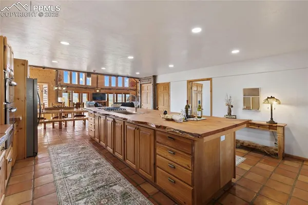 a kitchen with sink and refrigerator
