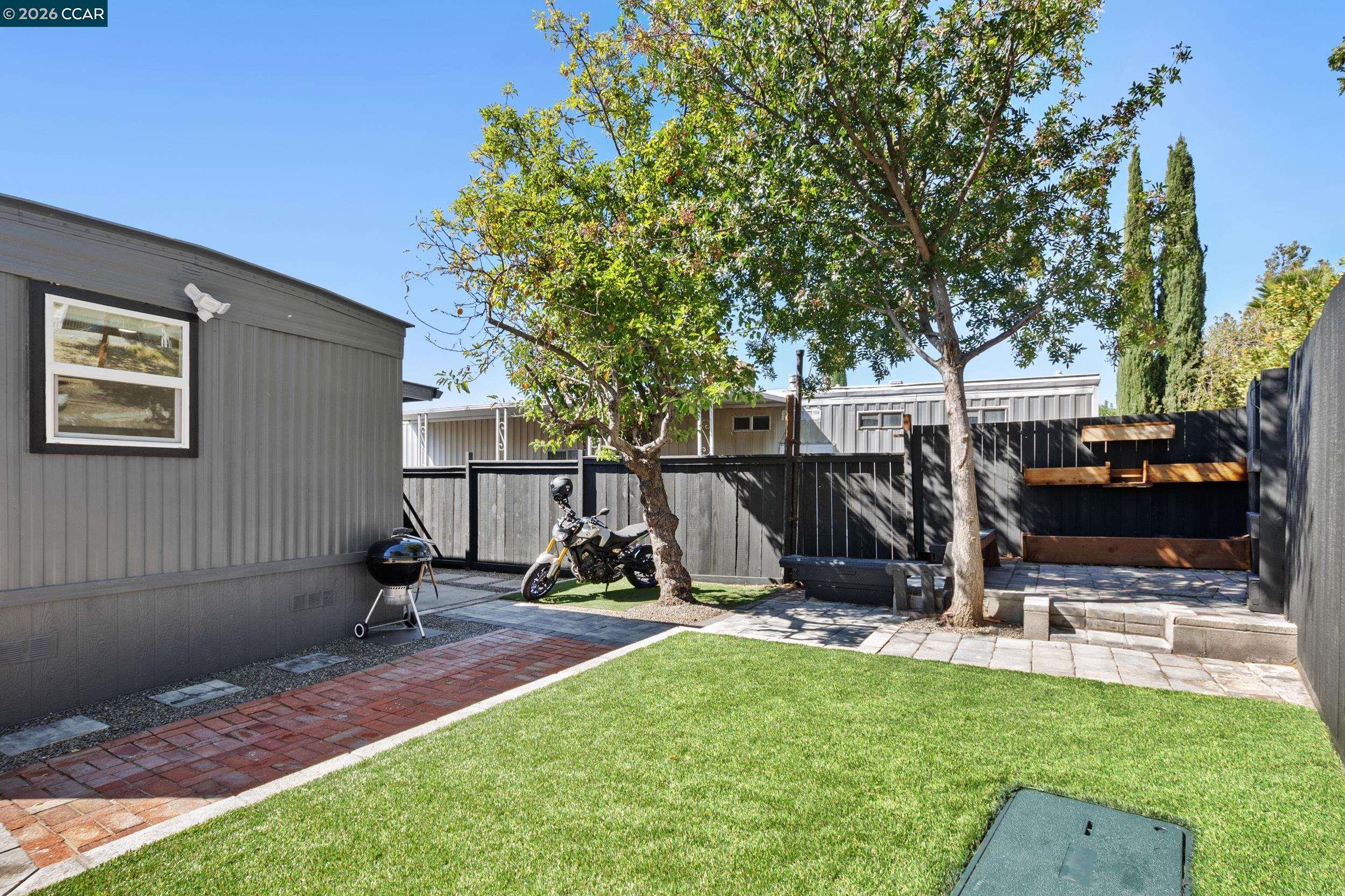32 Galloway Drive Concord, CA 94518 - Photo 31 of 35 a view of a backyard with a slide trees and wooden fence