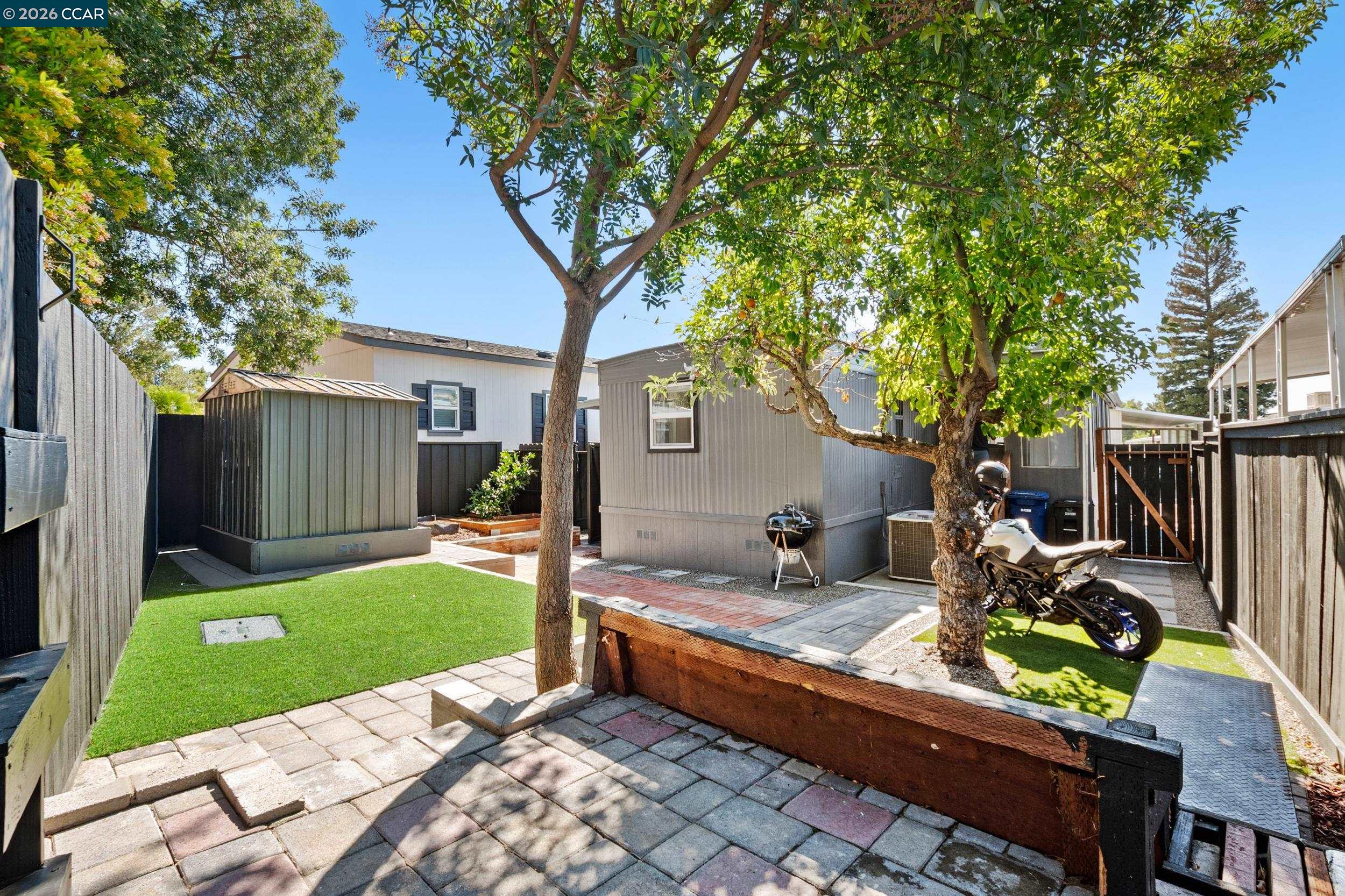 32 Galloway Drive Concord, CA 94518 - Photo 32 of 35 a view of backyard with a table and chairs and a large tree