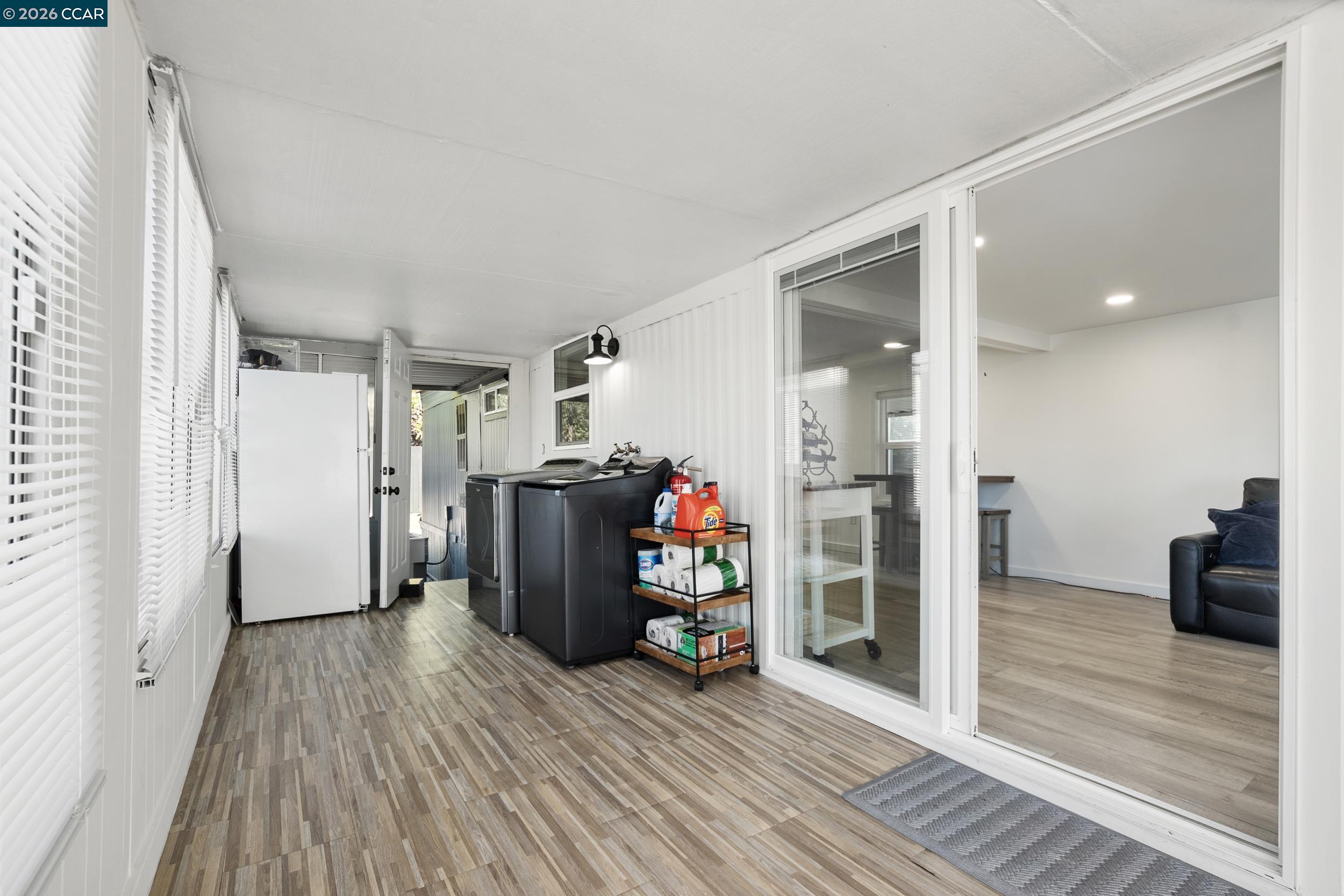 32 Galloway Drive Concord, CA 94518 - Photo 7 of 35 a view of a hallway with wooden floor and a refrigerator