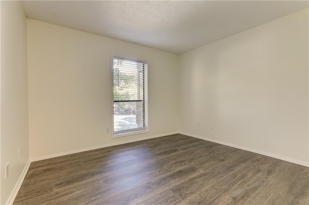 308 Wynnes Ridge Circle Southeast Marietta, GA 30067 - Photo 13 of 17 an empty room with wooden floor and windows
