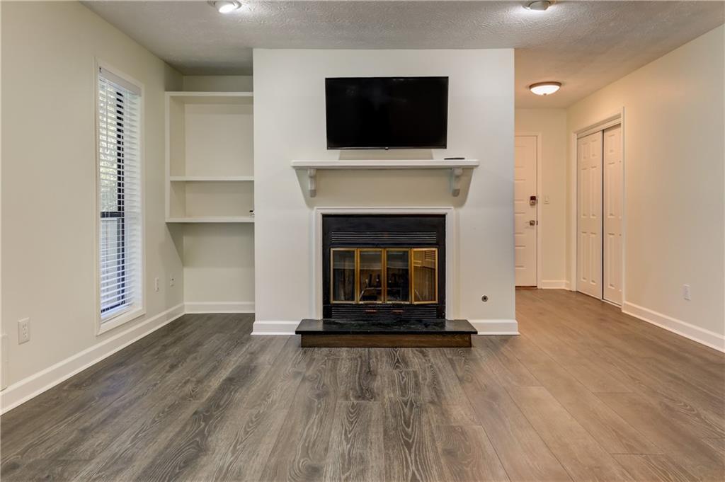 308 Wynnes Ridge Circle Southeast Marietta, GA 30067 - Photo 5 of 17 a living room with a fireplace and a flat screen tv
