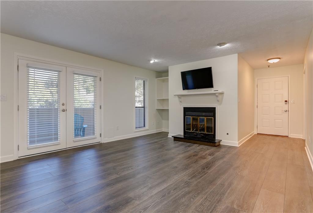 308 Wynnes Ridge Circle Southeast Marietta, GA 30067 - Photo 6 of 17 a view of empty room with wooden floor and fireplace