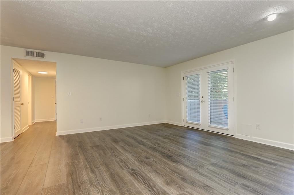 308 Wynnes Ridge Circle Southeast Marietta, GA 30067 - Photo 8 of 17 a view of an empty room with wooden floor and a window