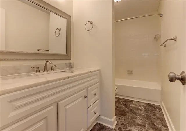 a bathroom with a sink a mirror and a bathtub