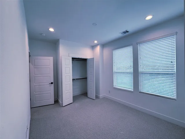 an empty room with a empty space and windows