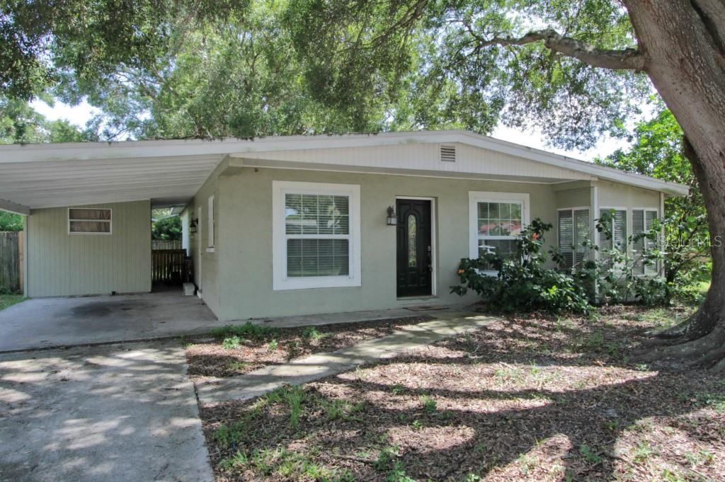 2906 West Winthrop Road Tampa, FL 33611 - Photo 1 of 1 a front view of a house with a yard and garage