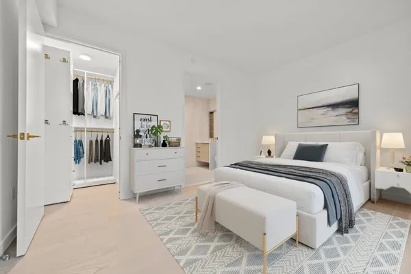 a spacious bedroom with a bed a couch and dresser