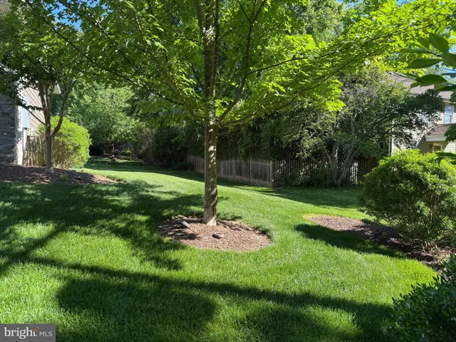 a view of empty room with wooden floor and fireplace