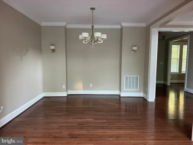 a kitchen with stainless steel appliances granite countertop a sink a stove and a wooden floor