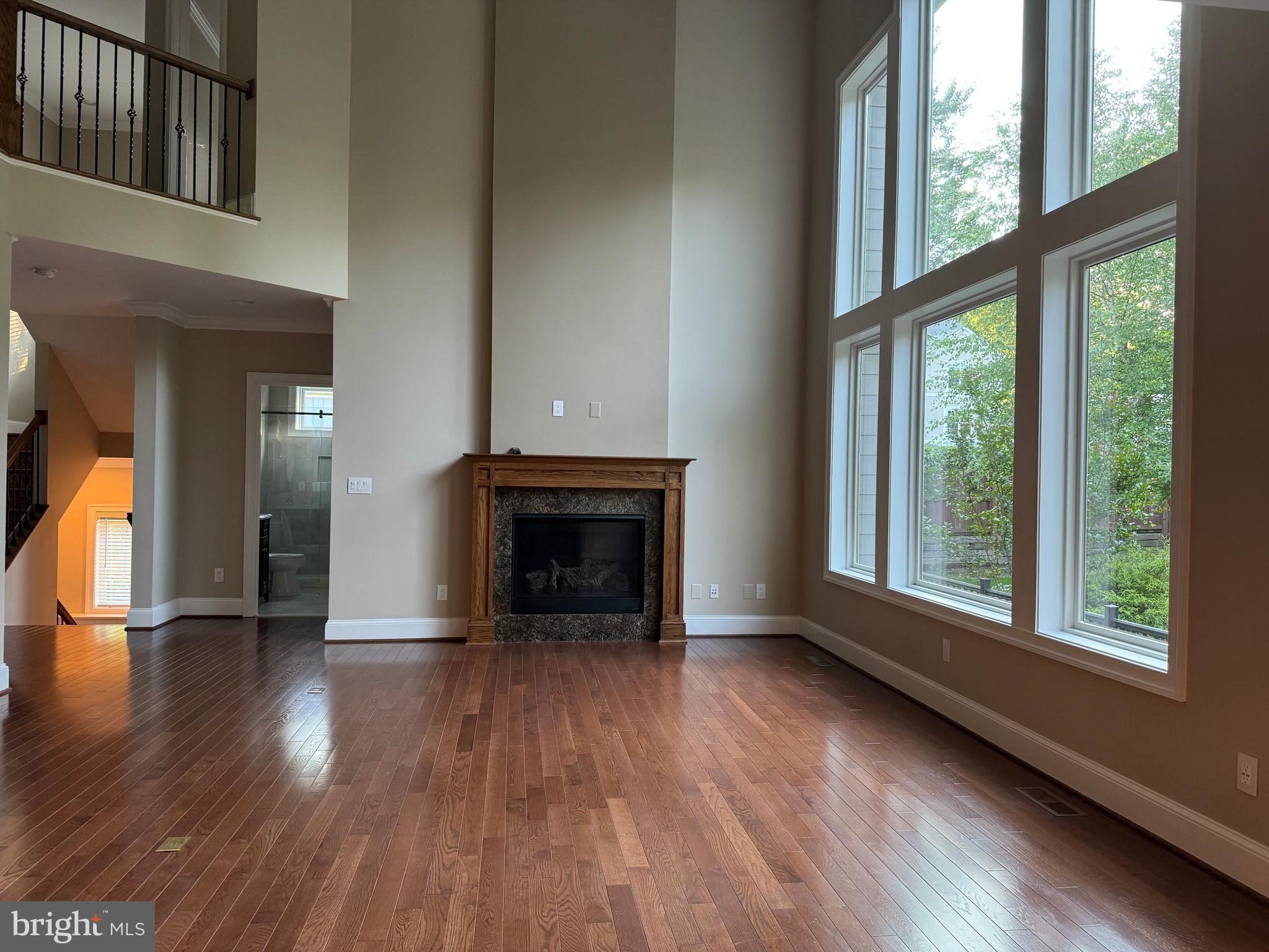 7702 Trammell Road Annandale, VA 22003 - Photo 16 of 68 a view of an empty room with wooden floor fire place and a window