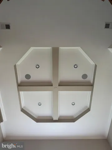 a large kitchen with kitchen island granite countertop a large window and stainless steel appliances