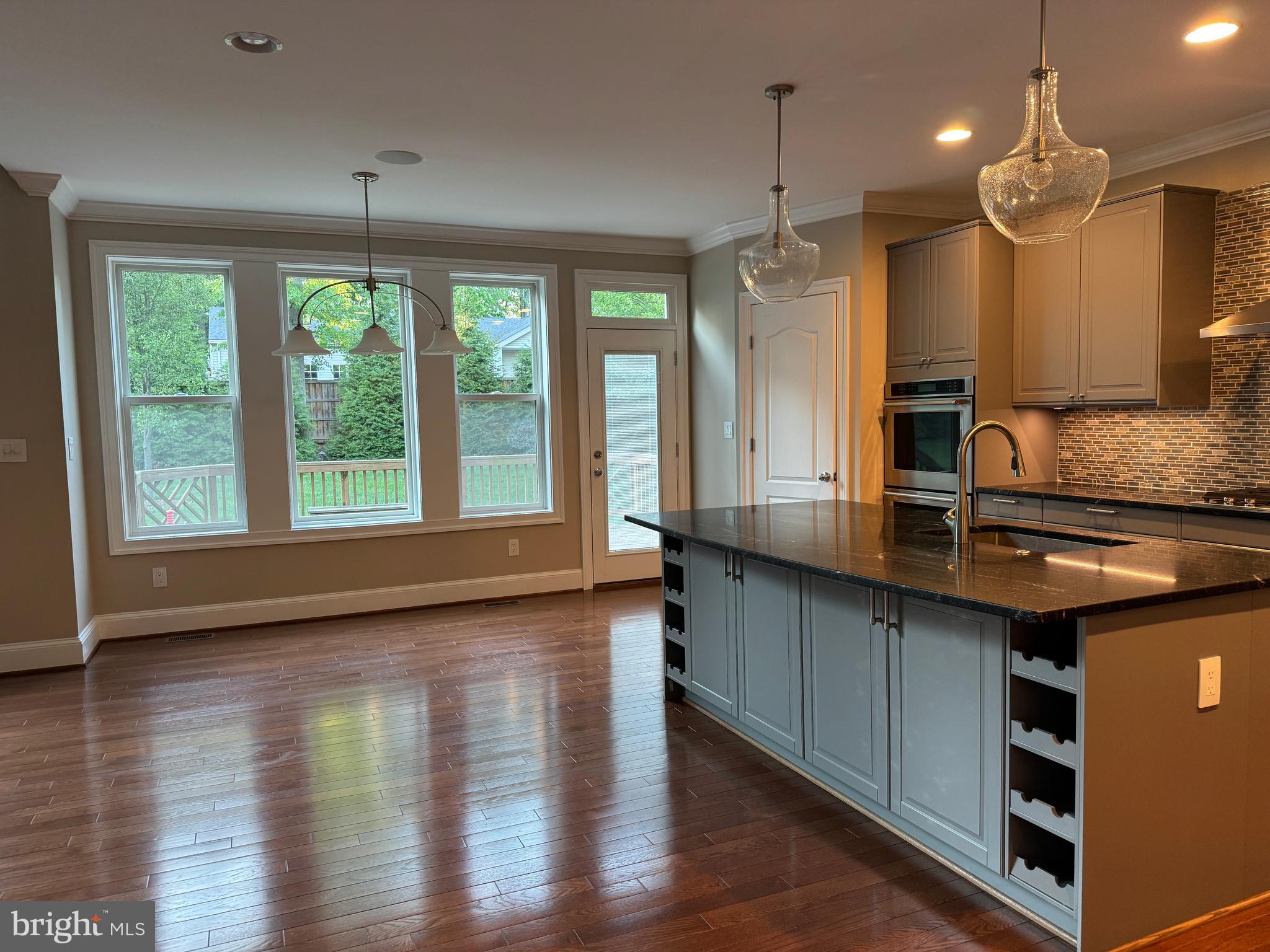 7702 Trammell Road Annandale, VA 22003 - Photo 26 of 68 a large kitchen with kitchen island granite countertop a large window and stainless steel appliances