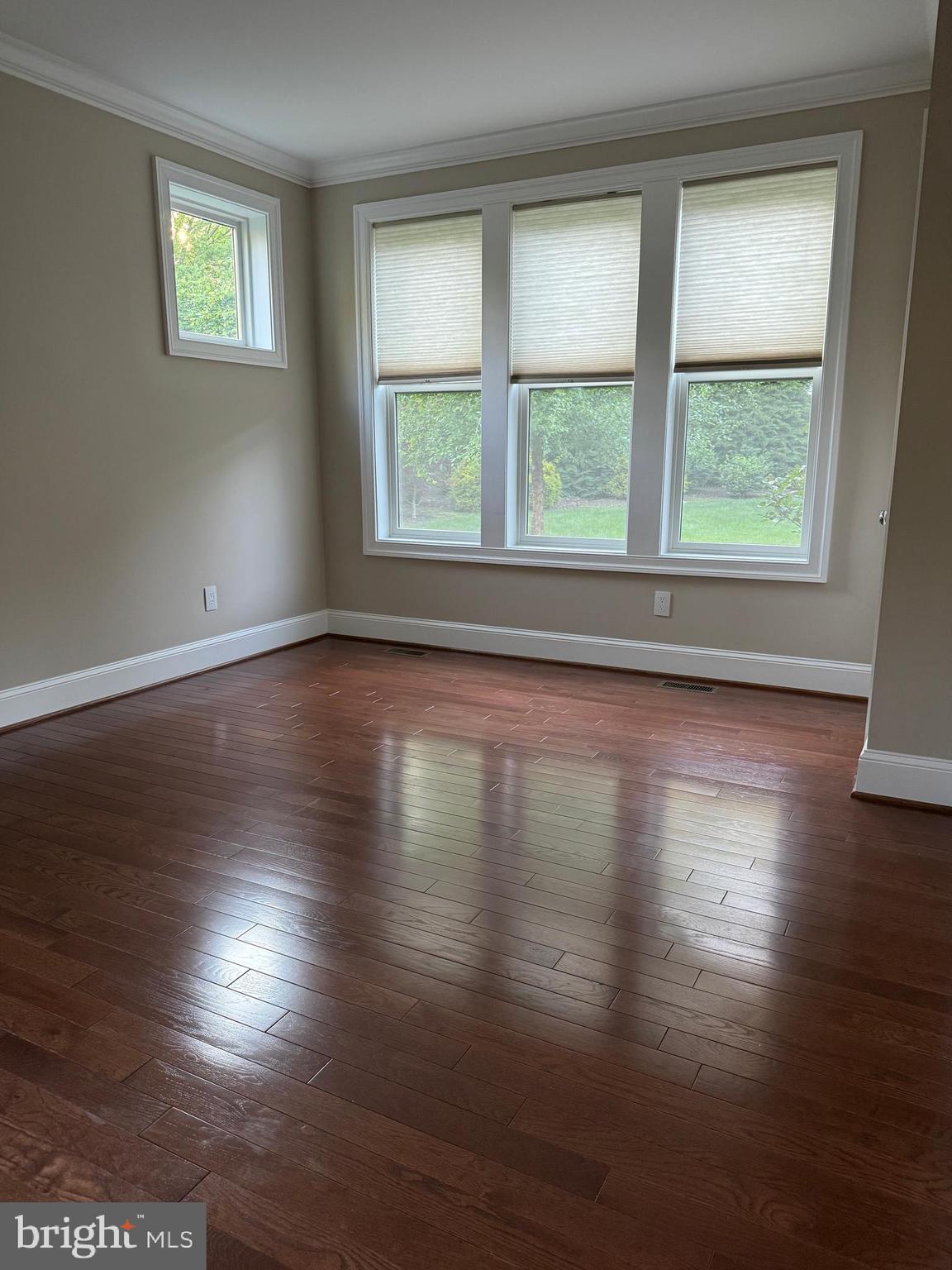 7702 Trammell Road Annandale, VA 22003 - Photo 32 of 68 an empty room with wooden floor and windows