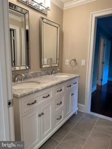 a bathroom with a tub a sink and a mirror