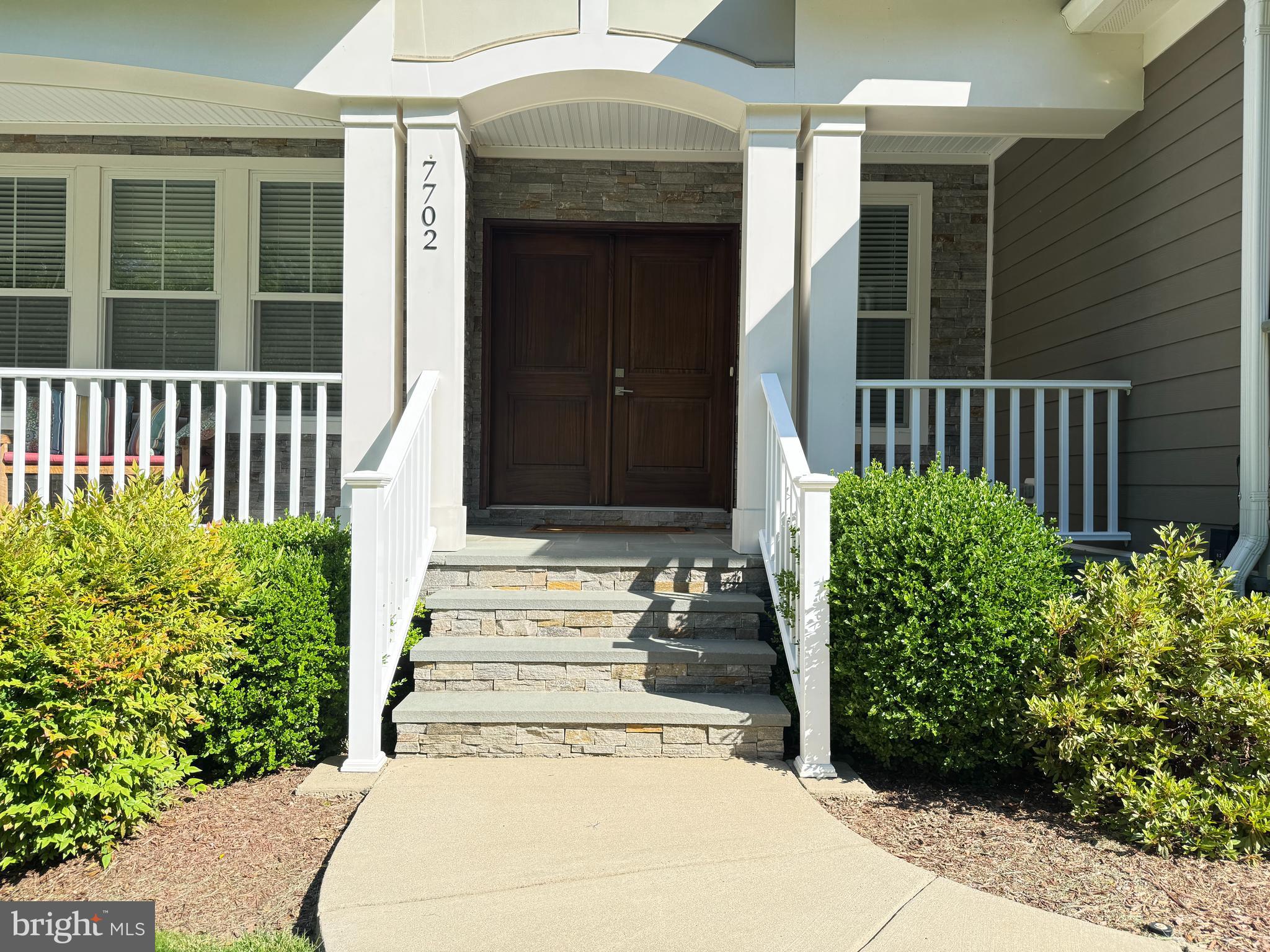 7702 Trammell Road Annandale, VA 22003 - Photo 4 of 68 a front view of a house with a garden