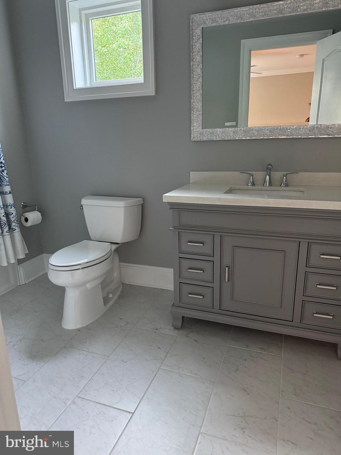 7702 Trammell Road Annandale, VA 22003 - Photo 44 of 68 a bathroom with a toilet sink and mirror