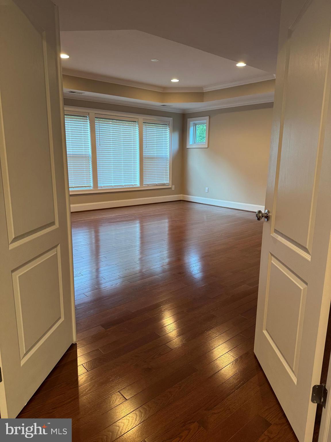 7702 Trammell Road Annandale, VA 22003 - Photo 47 of 68 an empty room with wooden floor and windows