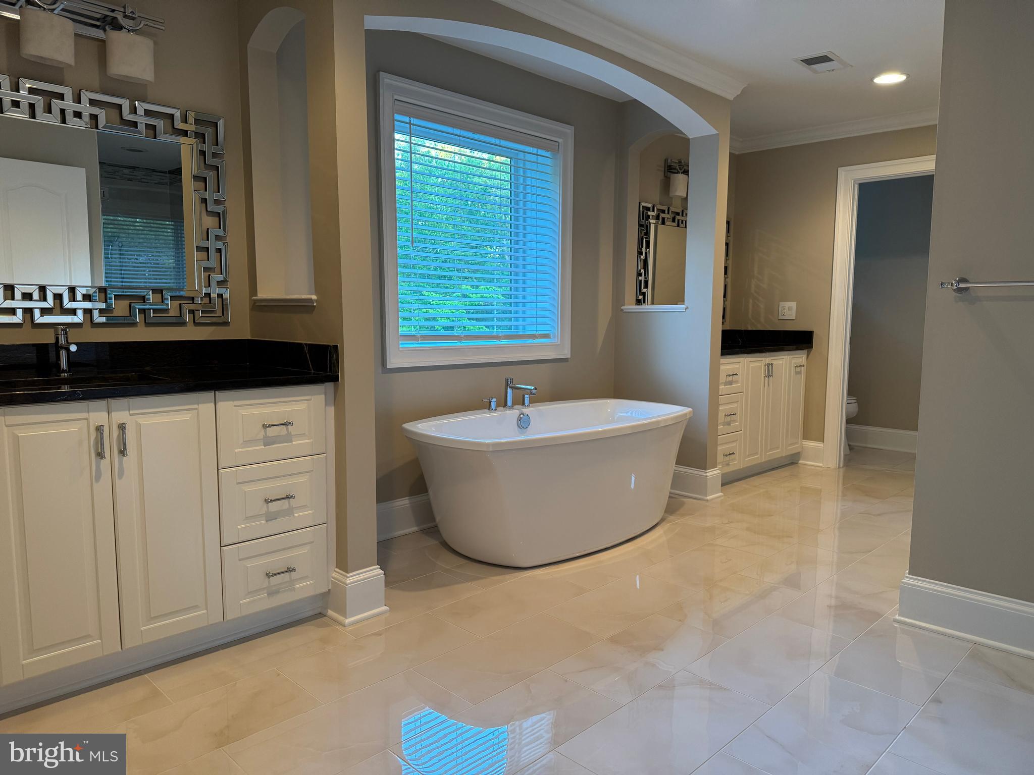 7702 Trammell Road Annandale, VA 22003 - Photo 51 of 68 a bathroom with a tub a sink and a mirror