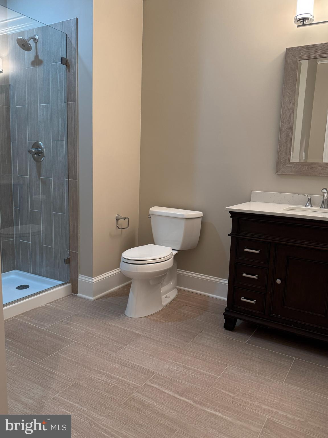 7702 Trammell Road Annandale, VA 22003 - Photo 62 of 68 a bathroom with a sink toilet a mirror and shower