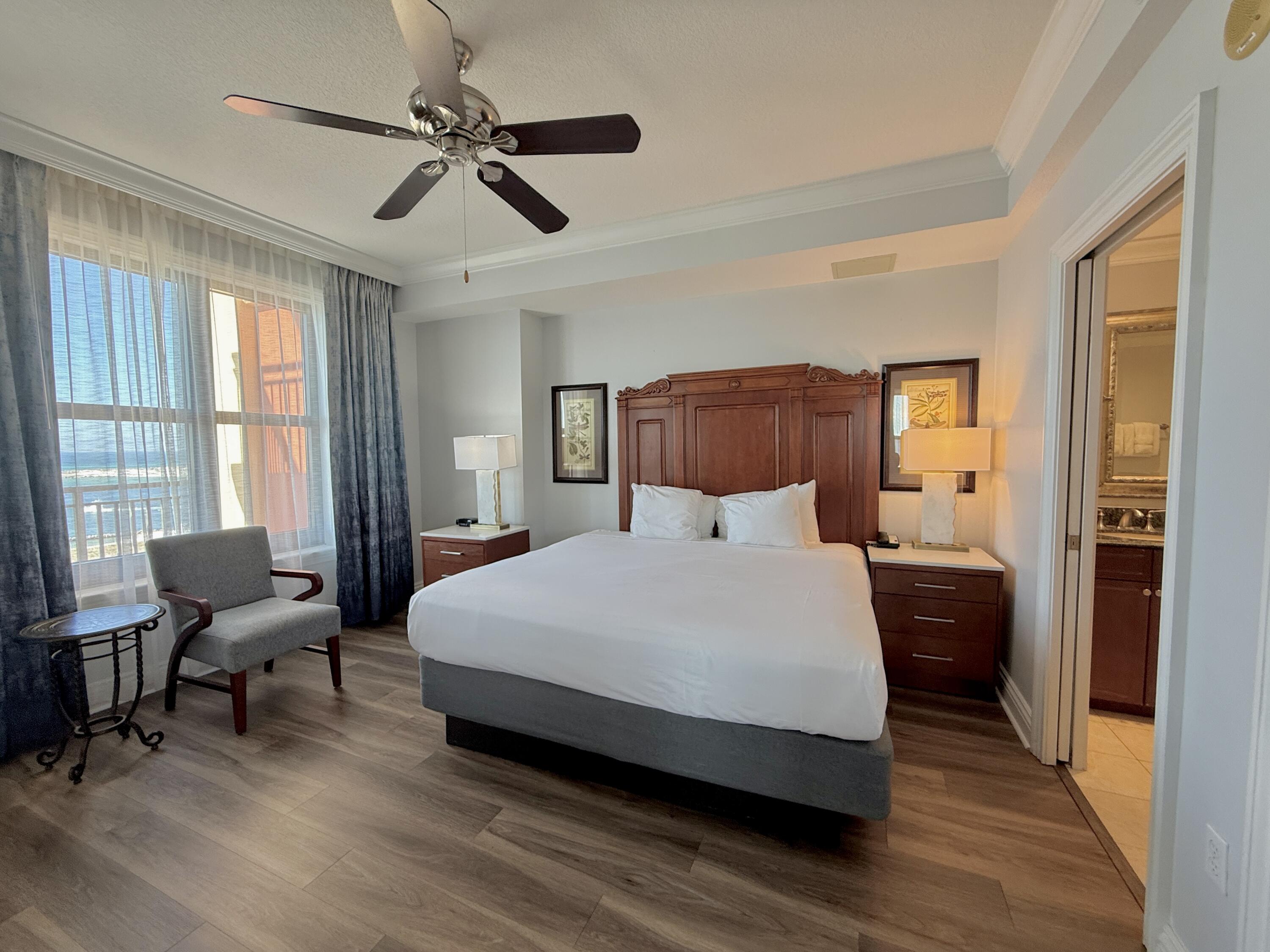 10 Harbor Boulevard, Unit E506E Destin, FL 32541 - Photo 17 of 29 a bedroom with a bed window and a couch