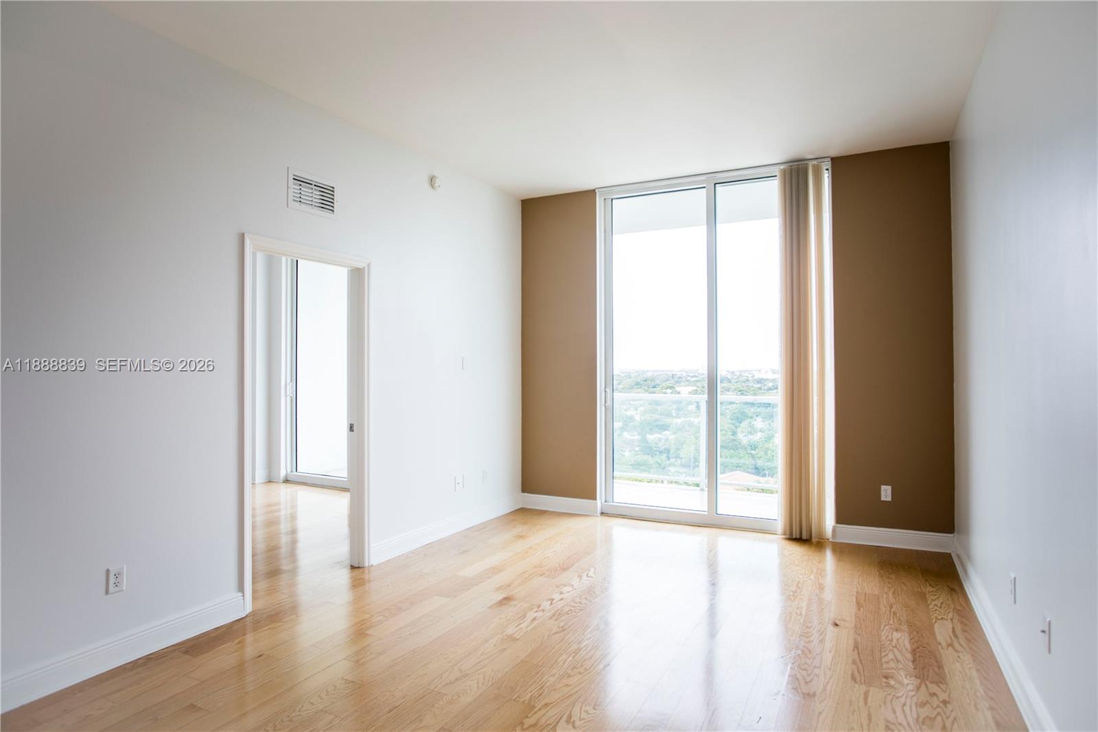 2525 Southwest 3rd Avenue, Unit 1106 Miami, FL 33129 - Photo 2 of 36 an empty room with wooden floor and windows