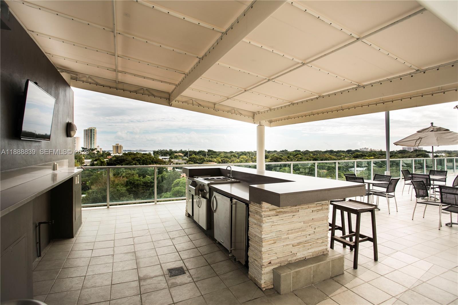2525 Southwest 3rd Avenue, Unit 1106 Miami, FL 33129 - Photo 21 of 36 a kitchen with stainless steel appliances granite countertop a stove a sink and a microwave