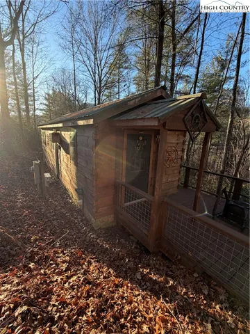 a view of a yard with wooden fence