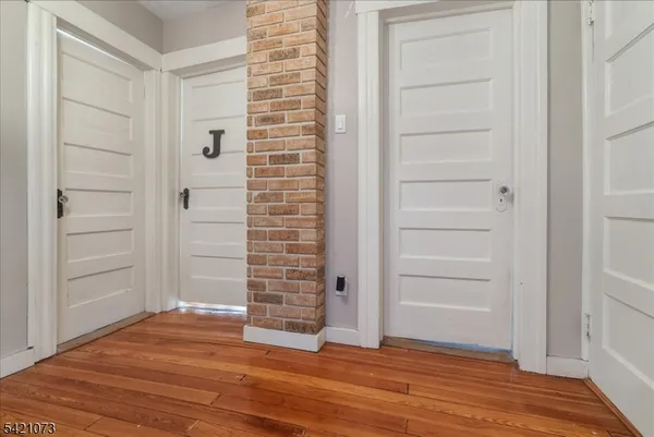 a bedroom with a bed and a flat tv screen on the dresser