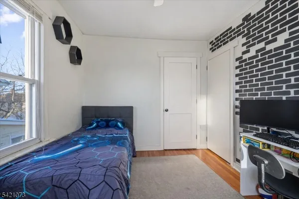 a bedroom with a bed and flat screen tv